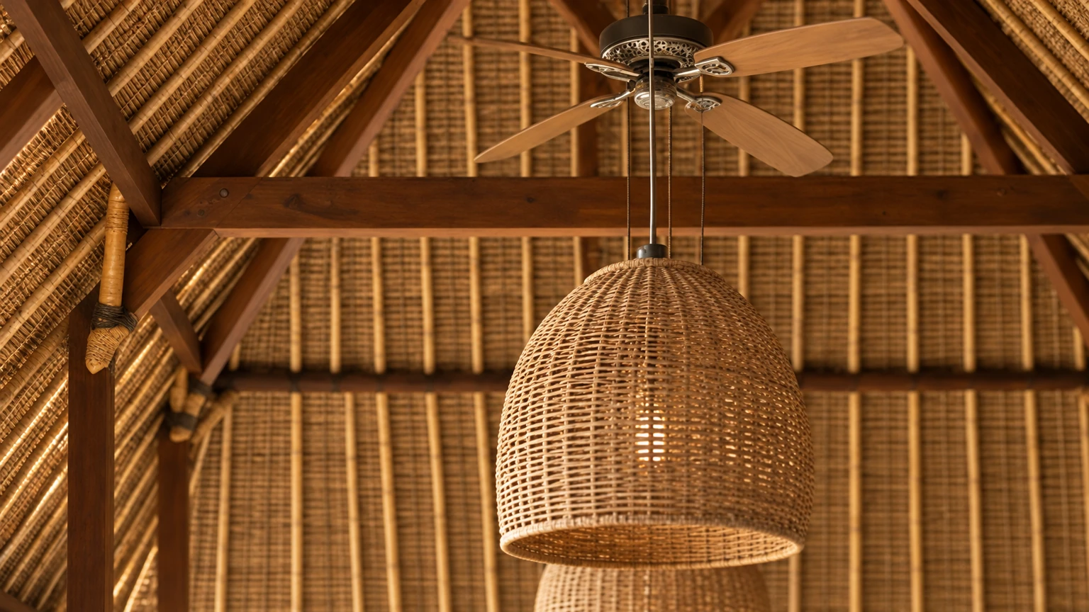 AI-generated Concept: close-set bamboo rafters and dark timber beams line the underside of a thatched roof, with a ceiling fan above a woven rattan pendant.